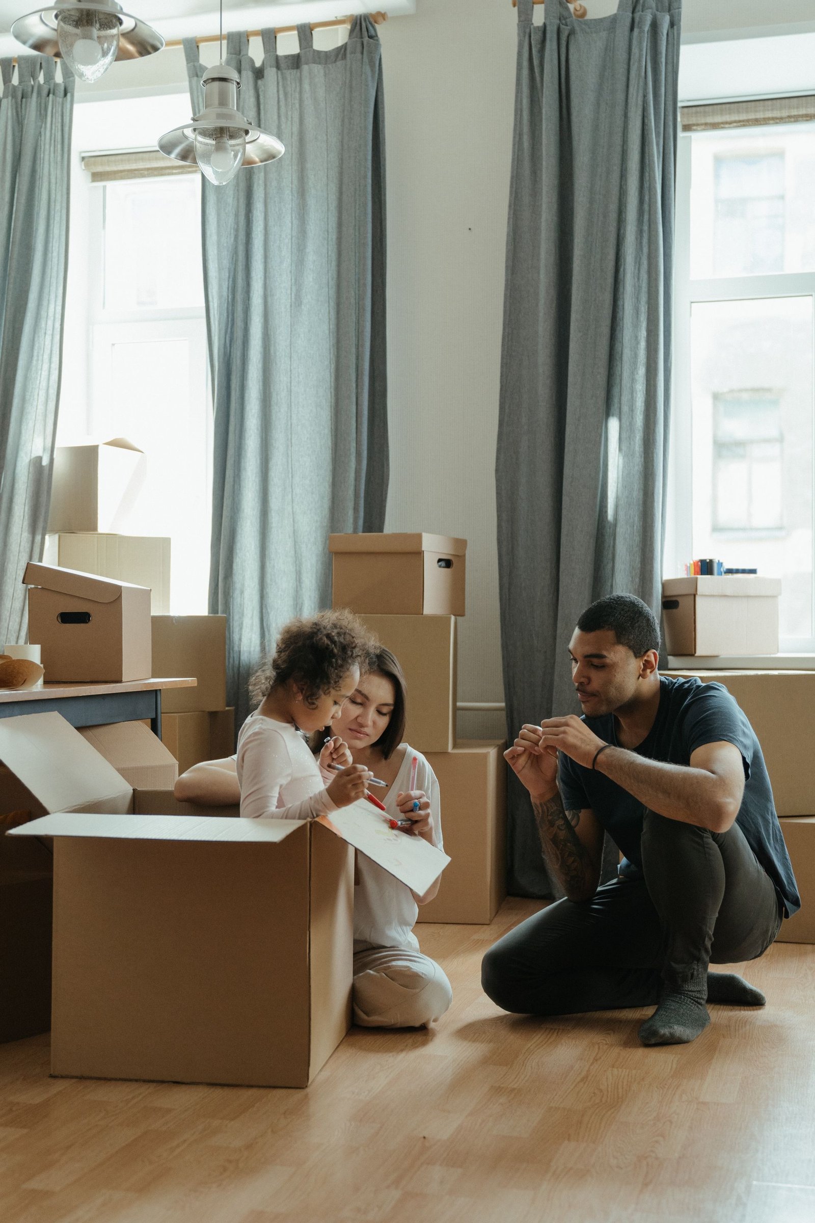 A family organizing cardboard boxes together in their new home