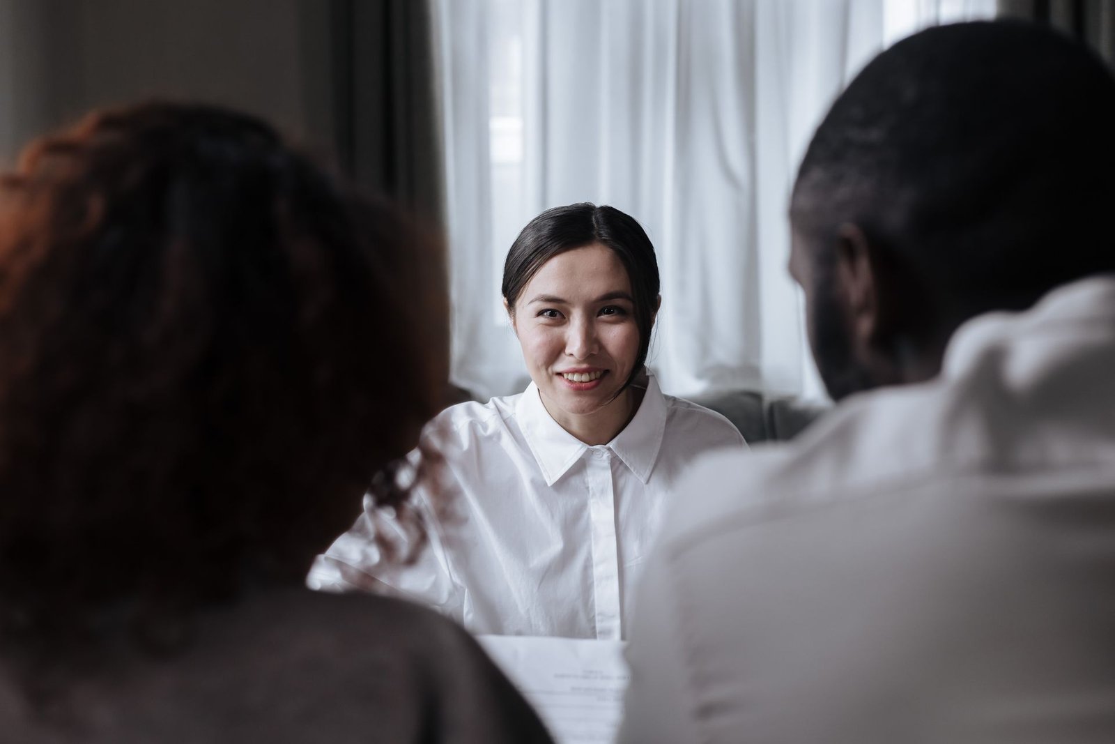 An advisor smiling while talking through plans with a couple